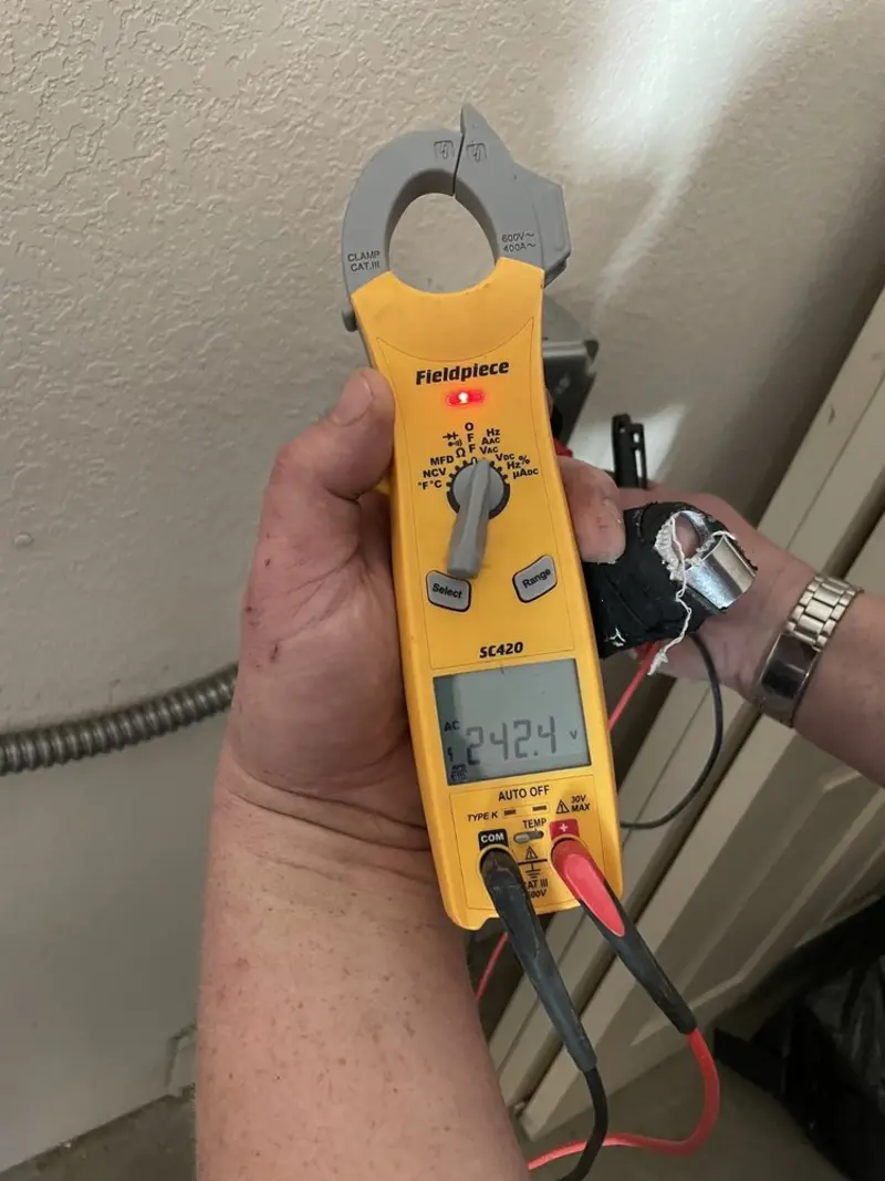 Voltage testing with clamp meter during Whole House Surge Protector in West Monroe